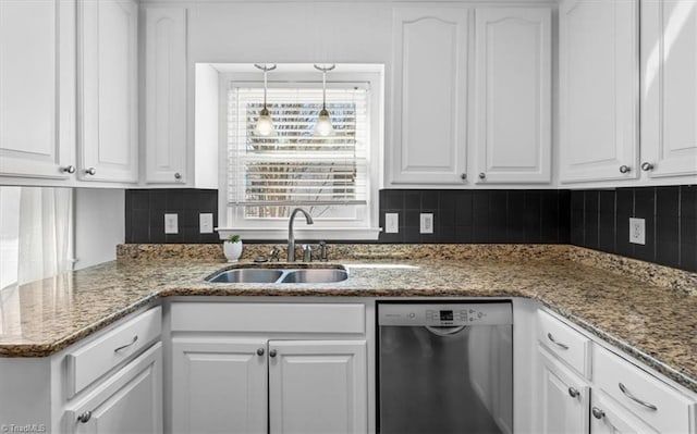 kitchen with decorative backsplash, white cabinets, dishwasher, and a sink