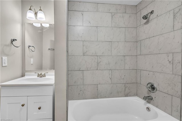 bathroom with vanity and tiled shower / bath