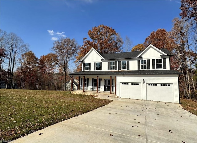 view of front of home featuring a front lawn, a porch, and a garage