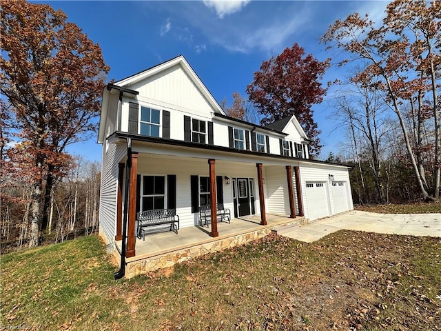 view of front of property with covered porch and a garage