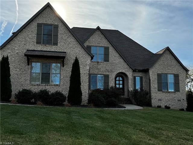 french provincial home featuring a front lawn