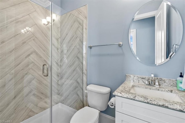 bathroom featuring vanity, toilet, and walk in shower