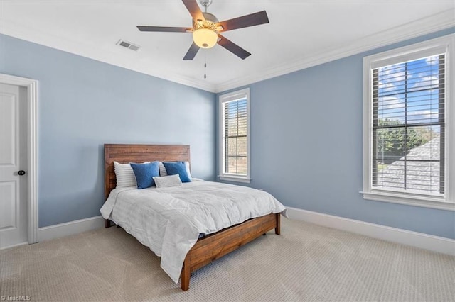 bedroom with ceiling fan, light carpet, and ornamental molding