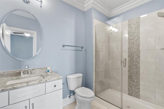 bathroom with toilet, vanity, ornamental molding, and a shower with door