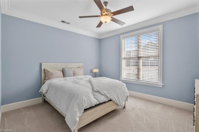 carpeted bedroom with ceiling fan and crown molding