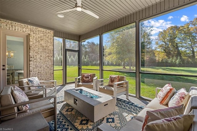 sunroom / solarium with wooden ceiling, a wealth of natural light, and ceiling fan