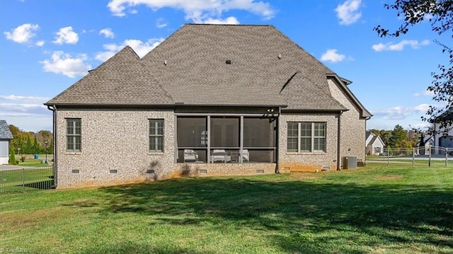 rear view of property featuring central AC, a lawn, and a sunroom