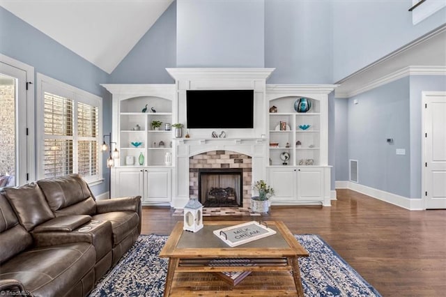 living room with a fireplace, dark hardwood / wood-style flooring, and high vaulted ceiling