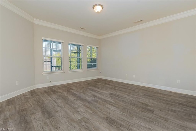 spare room featuring hardwood / wood-style floors and ornamental molding