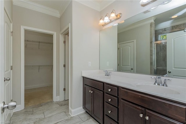 bathroom with vanity, crown molding, and walk in shower