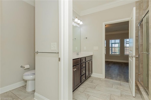 bathroom with vanity, crown molding, a shower with door, and toilet