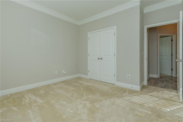 unfurnished bedroom with light carpet, ornamental molding, and a closet