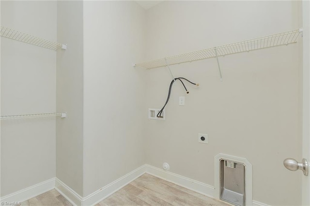 laundry room featuring hardwood / wood-style flooring, electric dryer hookup, and washer hookup