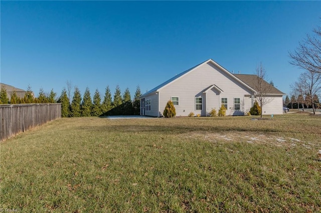 view of side of home with a lawn