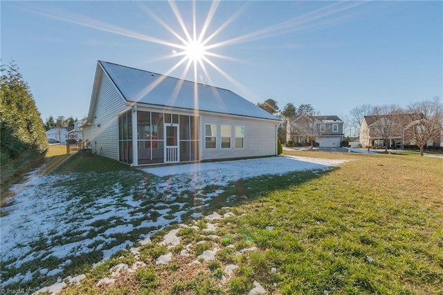 back of house featuring a sunroom, a yard, and a patio area