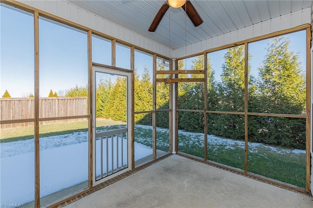 unfurnished sunroom featuring ceiling fan