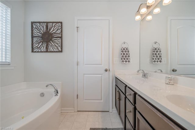 bathroom with a bath, tile patterned flooring, double vanity, and a sink