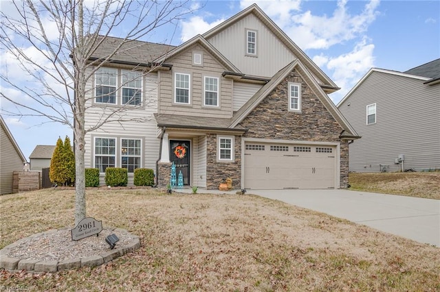 craftsman-style house with fence, driveway, an attached garage, stone siding, and board and batten siding