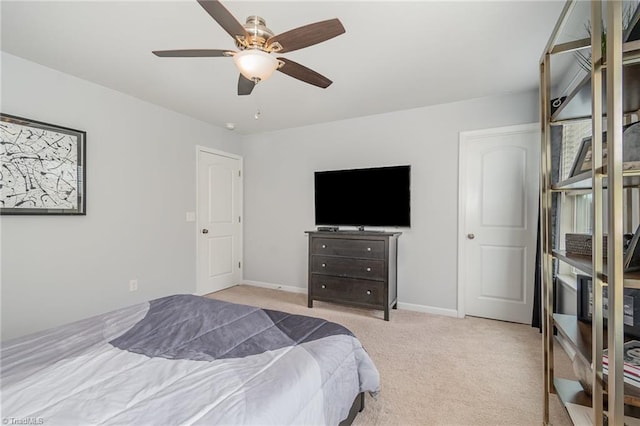 carpeted bedroom featuring baseboards and a ceiling fan