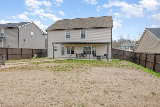 back of property featuring a fenced backyard and a patio area