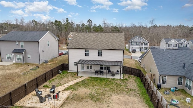 rear view of house featuring a patio, a fenced backyard, and a residential view