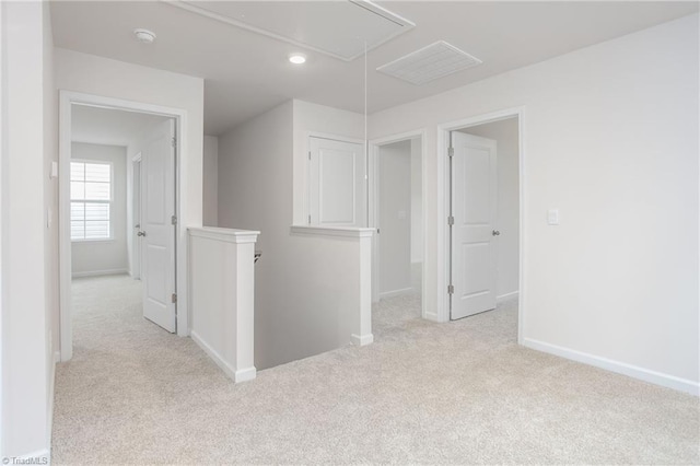 unfurnished room featuring light colored carpet