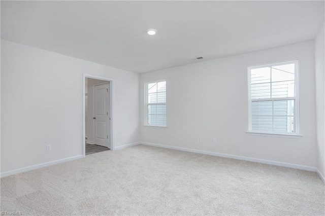 empty room featuring light carpet