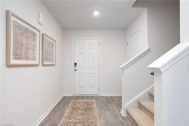 entryway with hardwood / wood-style floors