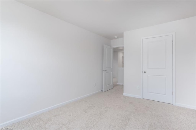 unfurnished bedroom featuring light colored carpet