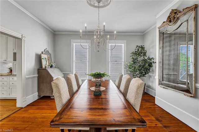 638 N Spring St, Winston-Salem, NC 27101 - dining area with a chandelier, hardwood / wood-style flooring, baseboards, and ornamental molding