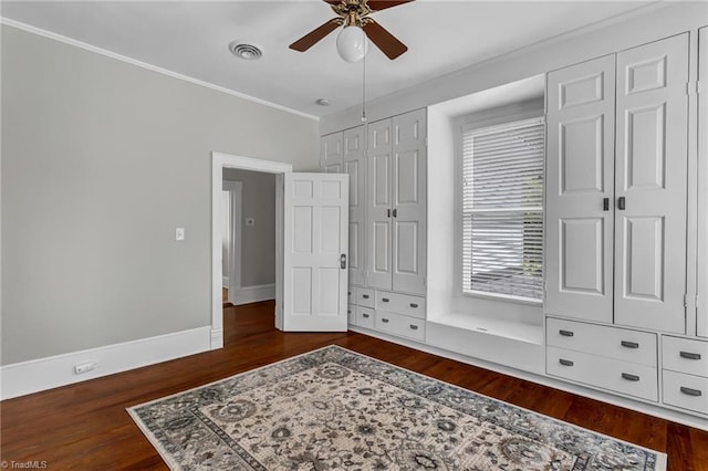 638 N Spring St, Winston-Salem, NC 27101 - bedroom featuring wood finished floors, crown molding, ceiling fan, baseboards, and multiple closets