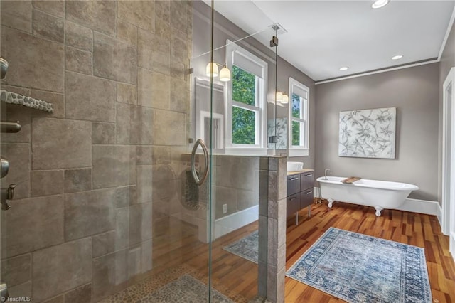 638 N Spring St, Winston-Salem, NC 27101 - bathroom with a stall shower, a soaking tub, wood finished floors, vanity, and recessed lighting