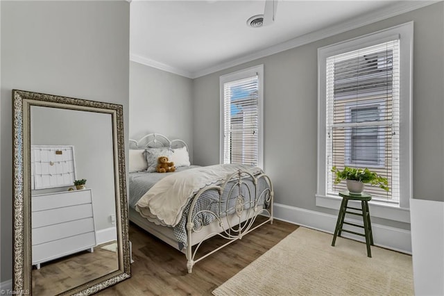 638 N Spring St, Winston-Salem, NC 27101 - bedroom featuring ornamental molding, wood finished floors, and baseboards