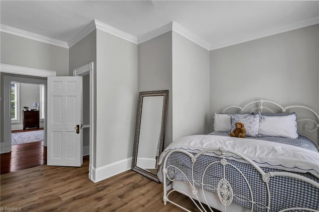 638 N Spring St, Winston-Salem, NC 27101 - bedroom featuring wood finished floors, ornamental molding, and baseboards