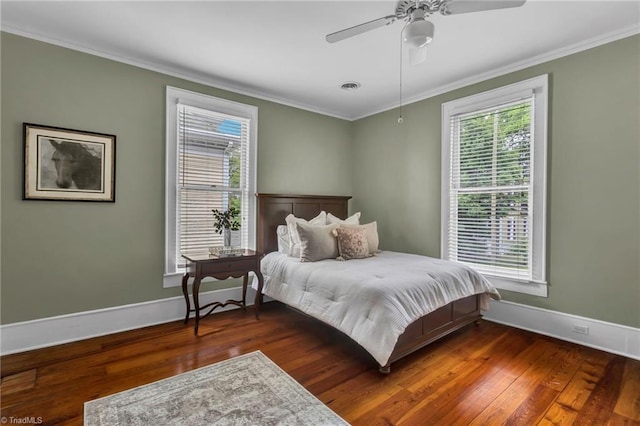 638 N Spring St, Winston-Salem, NC 27101 - bedroom featuring ornamental molding, baseboards, multiple windows, and wood finished floors