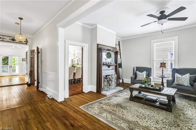 638 N Spring St, Winston-Salem, NC 27101 - living room with dark wood finished floors, ceiling fan, crown molding, and wainscoting