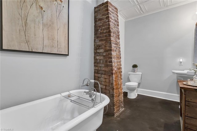638 N Spring St, Winston-Salem, NC 27101 - full bathroom with concrete floors, toilet, a freestanding tub, vanity, and ornamental molding