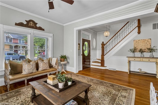 638 N Spring St, Winston-Salem, NC 27101 - living area with stairway, wood finished floors, ornamental molding, ceiling fan, and wainscoting