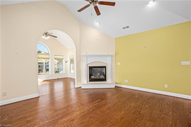 unfurnished living room featuring ceiling fan, vaulted ceiling, and hardwood / wood-style floors