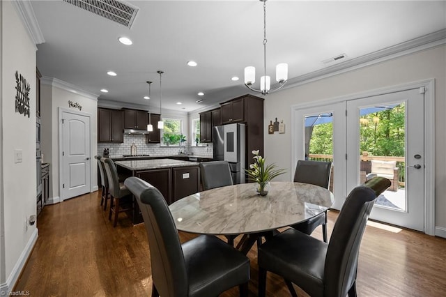 2590 Mccullum Ct, Browns Summit, NC 27214 - dining area with ornamental molding, recessed lighting, dark wood-style flooring, french doors, and a chandelier