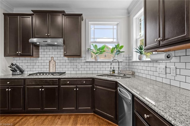 2590 Mccullum Ct, Browns Summit, NC 27214 - kitchen featuring stainless steel appliances, under cabinet range hood, ornamental molding, light stone countertops, and plenty of natural light