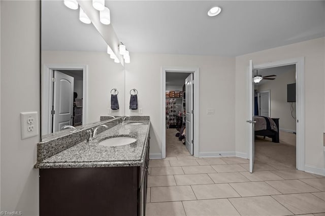 2590 Mccullum Ct, Browns Summit, NC 27214 - full bathroom with double vanity, tile patterned floors, ceiling fan, and a walk in closet