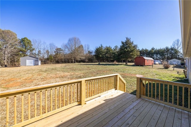 wooden terrace featuring a yard and a storage unit