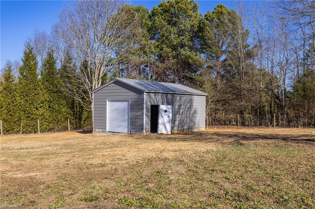 view of outbuilding with a garage and a yard