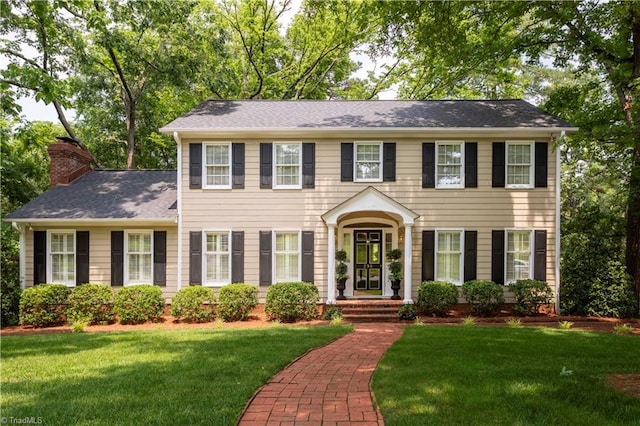 298 Duke Dr, Lexington, NC 27292 - colonial-style house with a front lawn, a chimney, and roof with shingles