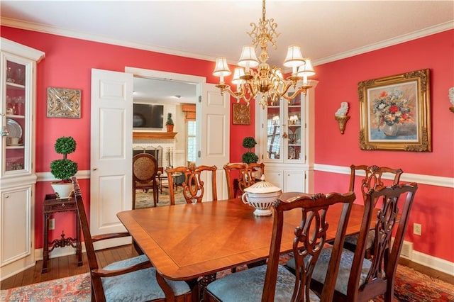 298 Duke Dr, Lexington, NC 27292 - dining area featuring hardwood / wood-style flooring, a chandelier, ornamental molding, and a brick fireplace