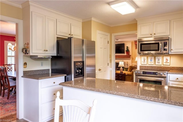 298 Duke Dr, Lexington, NC 27292 - kitchen featuring appliances with stainless steel finishes, ornamental molding, dark stone countertops, white cabinets, and wood finished floors
