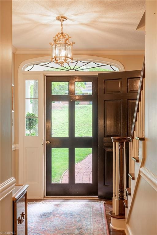 298 Duke Dr, Lexington, NC 27292 - foyer entrance with crown molding, a chandelier, stairway, and healthy amount of natural light