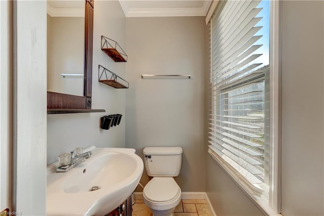 bathroom with tile patterned floors, toilet, sink, and ornamental molding