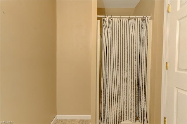 bathroom featuring tile patterned flooring and a shower with curtain